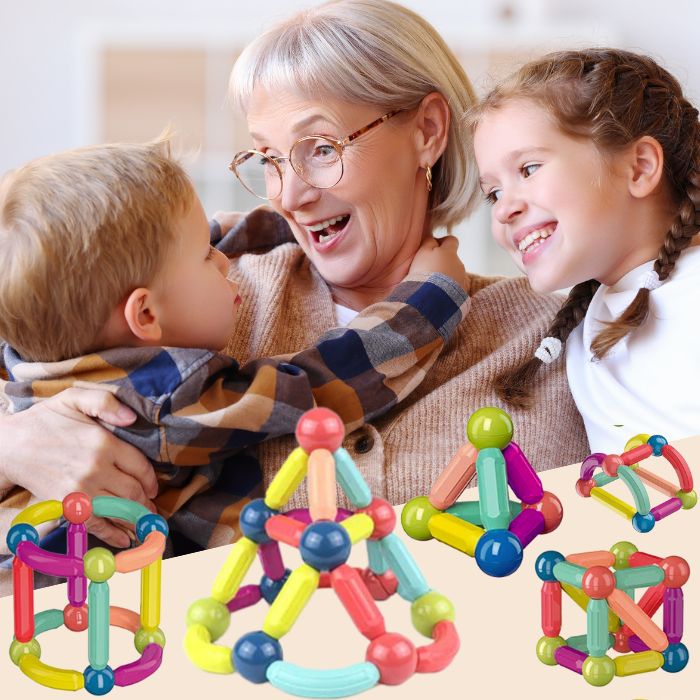 Enfant de 4 ans qui joue avec ses grand-parents dans le salon avec un jeu de construction magnétique et jeu aimanté